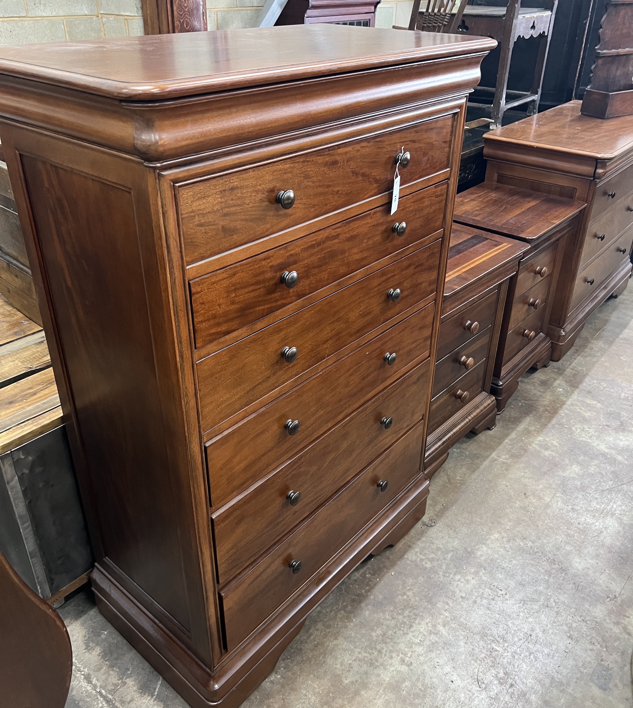 A contemporary five piece French mahogany bedroom suite, comprising sleigh bed, width 190cm, length 220cm, height 102cm (missing some bolts), a six drawer tall chest, three drawer chest and a pair of bedside chests